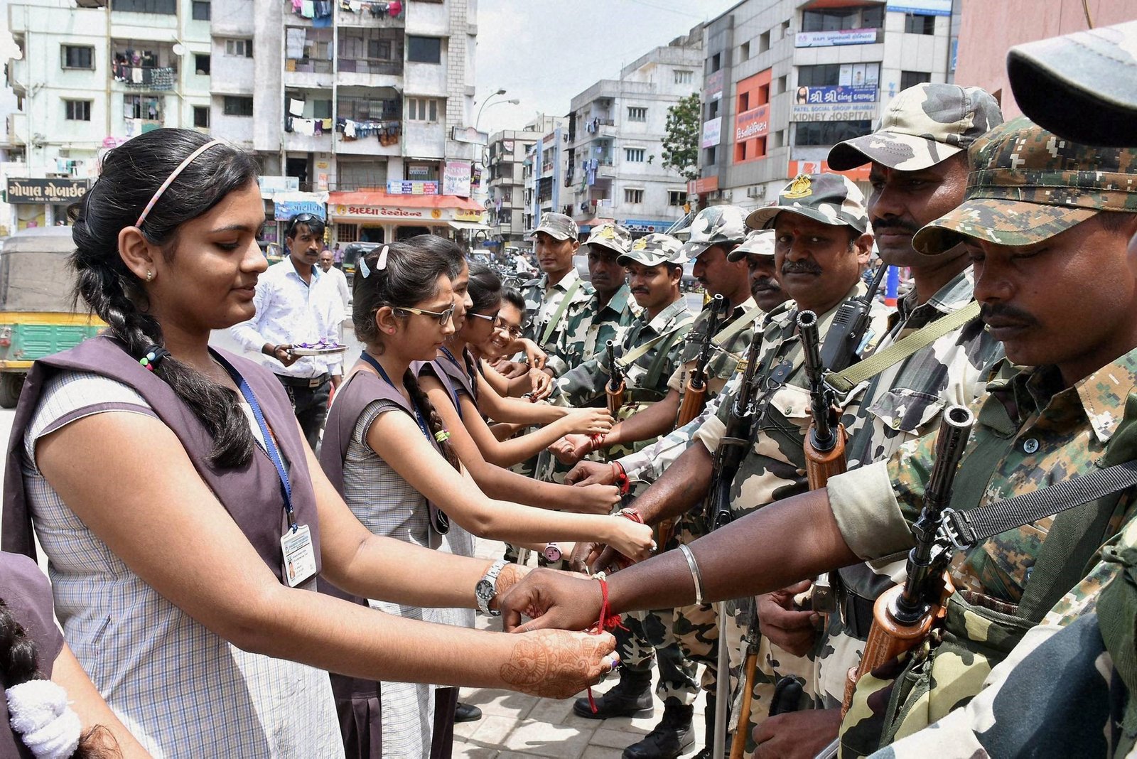 Girls binding Raakhi on Soldier wrists